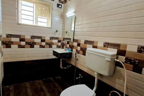 a bathroom with a toilet and a sink at iSTAYS - Luxe Villa, Yercaud in Yercaud
