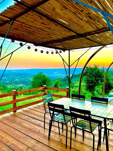 a wooden deck with a table and chairs on it at B&B Fontanelle in Alviano
