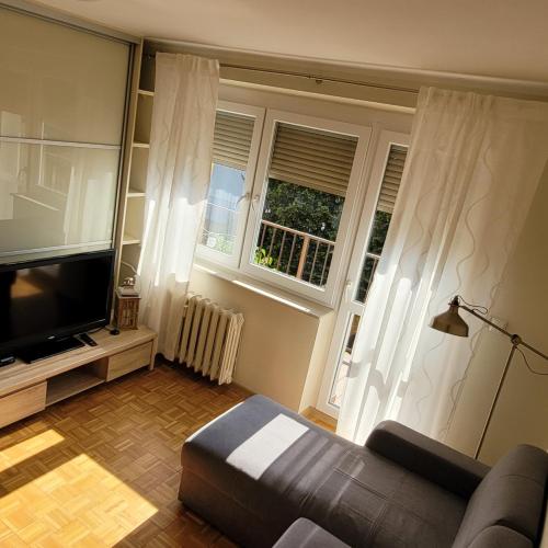 a living room with a couch and a flat screen tv at Apartament in Nakło nad Notecią