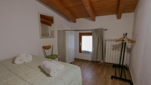 a bedroom with a bed with towels on it at Villa Maria in Mamoiada