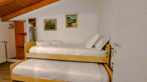 two bunk beds in a room with a door at Villa Maria in Mamoiada