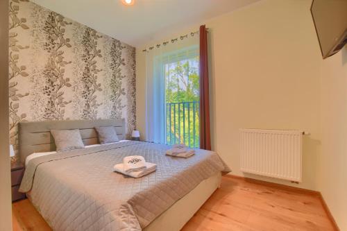 A bed or beds in a room at Hike & Ski Wisła