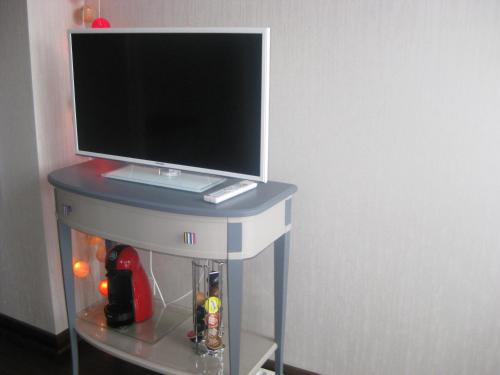 a computer monitor sitting on top of a desk at Aux Portes de Rennes Ch. d'hôtes in Chartres-de-Bretagne