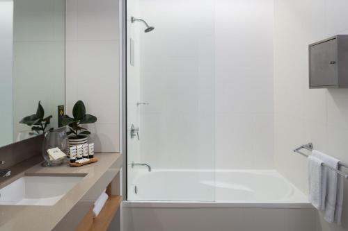a bathroom with a shower and a sink at Atura Dandenong in Dandenong