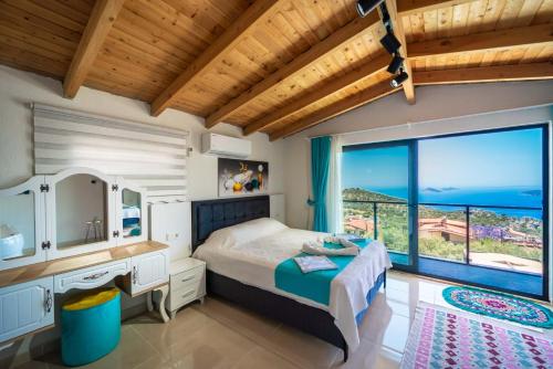 a bedroom with a bed and a large window at KaşKalkan Honeymoon Villa with Seaview in Kalkan