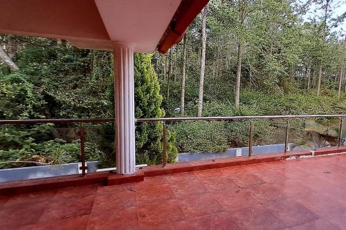 a balcony of a house with a view of trees at iSTAYS - Luxe Villa, Yercaud in Yercaud