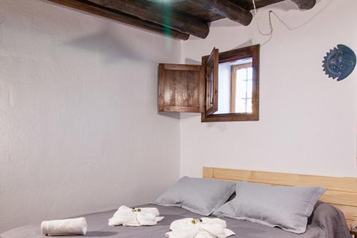 a bedroom with a bed with towels on it at Molino de Santa Águeda in Jerez del Marquesado