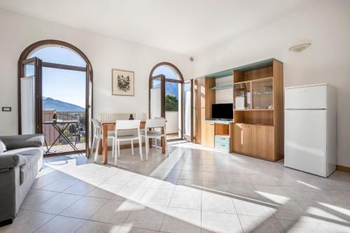 a kitchen and living room with a table and chairs at Appartamenti Villa Belvedere in Arco