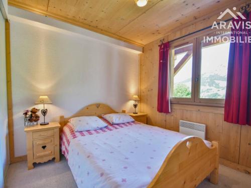 a bedroom with a large bed and a window at Appartement Le Grand-Bornand, 2 pièces, 4 personnes - FR-1-391-107 in Le Grand-Bornand