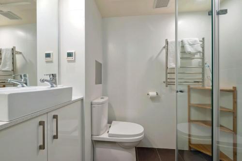a bathroom with a toilet and a sink and a shower at Lantern 1 Bedroom Balcony with amazing view in Thredbo