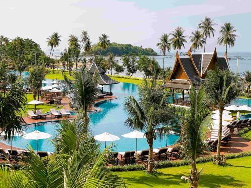 an aerial view of a resort with a pool and palm trees at Sofitel Krabi Phokeethra Golf and Spa Resort in Klong Muang Beach