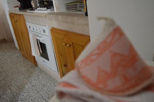 a kitchen with a stove and a counter top at Trullo Pugliese in Alberobello