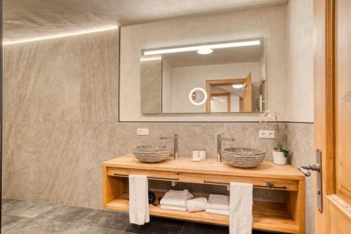 a bathroom with a sink and a mirror at Appartement Hofmann in Königsleiten