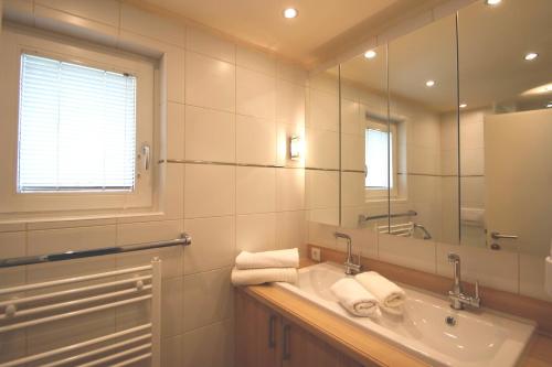 a bathroom with a sink and a mirror at Alpenlandhaus Menardi in Seefeld in Tirol