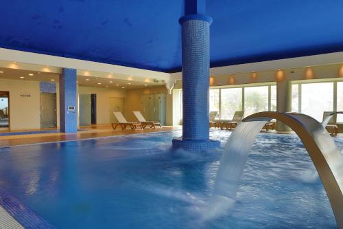 a indoor swimming pool with a water fountain at Be Live Collection Saïdia in Saidia 