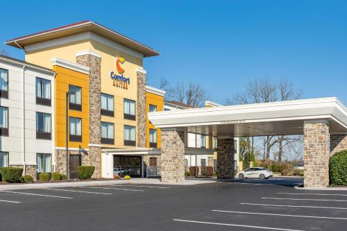 a hotel with a car parked in a parking lot at Comfort Suites Lancaster Amish Country in Lancaster