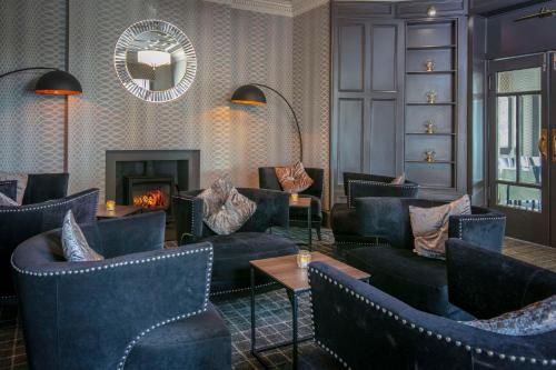 a lobby with couches and a fireplace and a mirror at Sure Hotel by Best Western Lockerbie in Lockerbie