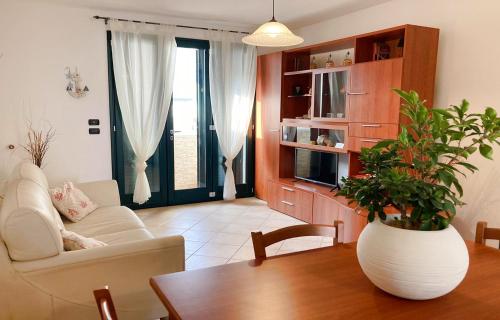 レウカにあるLeuca Villetta Vista Mareのリビングルーム(ソファ、植物のあるテーブル付)