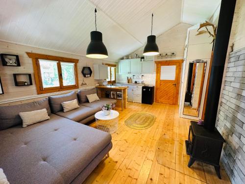 a living room with a couch and a table at Cesemino Farmhouse in Czyżemin
