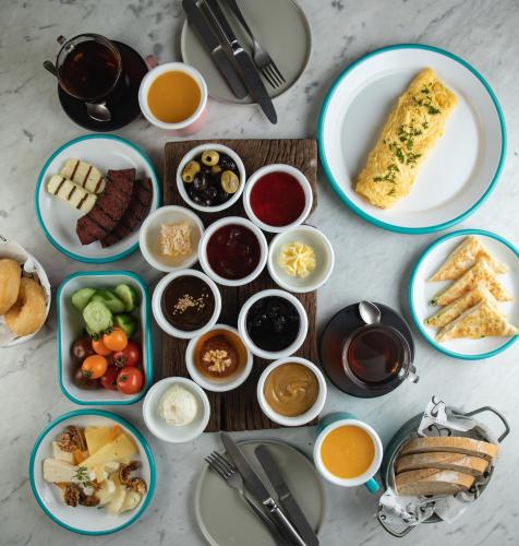 a table topped with plates of food and bowls of dips at Stayso The House Hotel in Istanbul