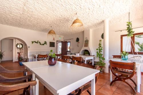 a dining room with a white table and chairs at Villa Principezinho in Portimão