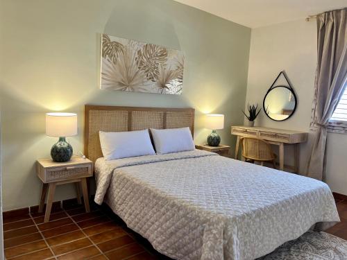 a bedroom with a bed and two lamps and a mirror at Brisa Marina, Altea in Alicante