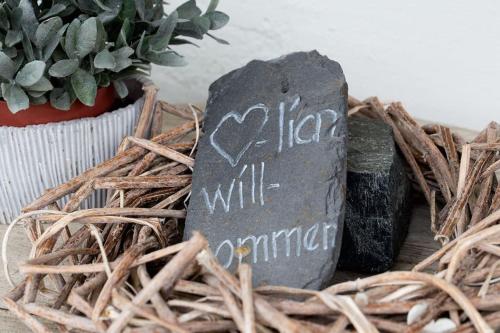 a sign that says hello will summarize sitting in a wicker basket at Fiesch-Lax Minnig Moritz in Lax