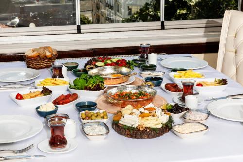 a table with many different dishes of food on it at Hotel Ipek Palas in Istanbul