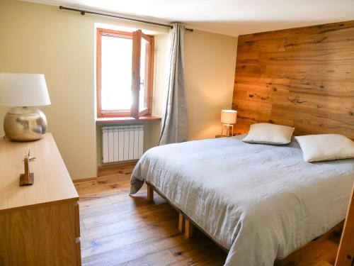 - une chambre avec un lit et un mur en bois dans l'établissement Nuovo Appartamento moderno a Cogne, à Cogne
