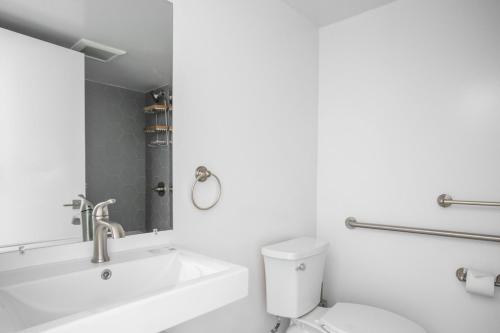 a bathroom with a sink and a toilet and a mirror at Brentwood 1br w gym rooftop nr shops bars LAX-1076 in Los Angeles