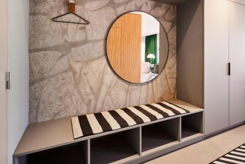 a dressing room with a mirror and a bench at Kirk Suites in Vejle