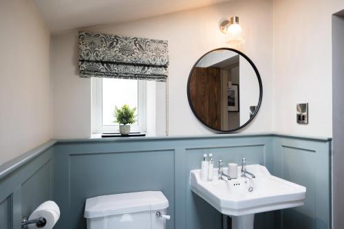 a bathroom with a sink and a mirror at Low Thearns in Barnard Castle