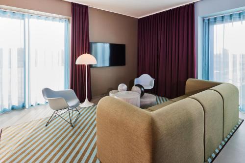 a living room with a couch and a table at Kirk Suites in Vejle