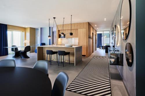 a kitchen and dining room with a table and chairs at Kirk Suites in Vejle