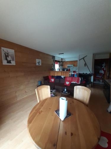 a wooden table and chairs in a living room at studio cabine Chatel in Châtel