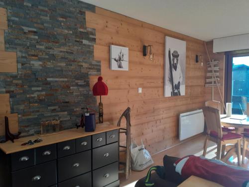 a room with a dresser and a brick wall at studio cabine Chatel in Châtel