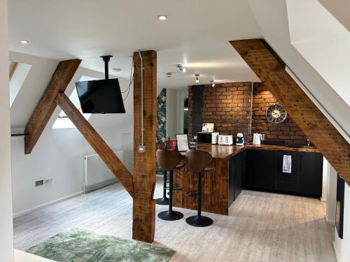 a kitchen with a bar in a loft at Cardiff Arms Bistro & Hotel in Treorky