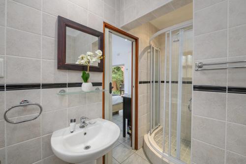 a bathroom with a sink and a shower at San Lameer Villa 2908 - 3 Bedroom Superior - 6 pax - San Lameer Rentals Agency in Southbroom