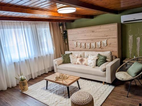 a living room with a couch and a table at Tokaj Zlatá Putňa - Restaurant & Pension in Viničky