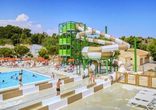 un parc aquatique avec un toboggan et une piscine dans l'établissement Mobil-home Clim, TV - Camping Narbonne-Plage 4 étoiles - MH-A015, à Narbonne-Plage