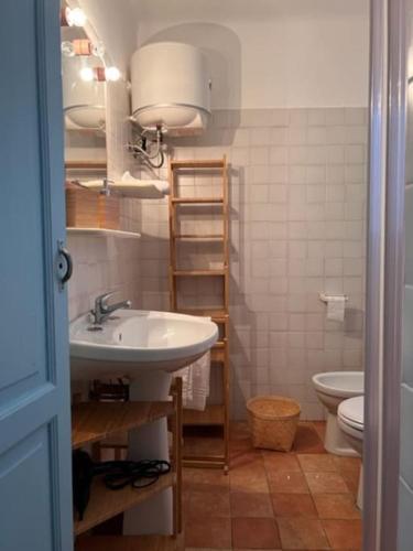 a bathroom with a sink and a toilet at La Locanda di Felisiano in Monopoli