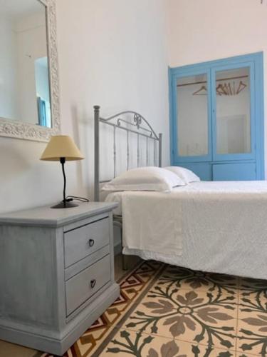 a bedroom with a bed and a table with a lamp at La Locanda di Felisiano in Monopoli