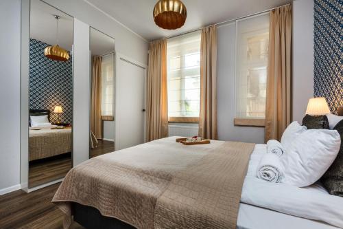 a bedroom with a large bed and a mirror at Happy Stay Sopot Monte Cassino 44 A in Sopot