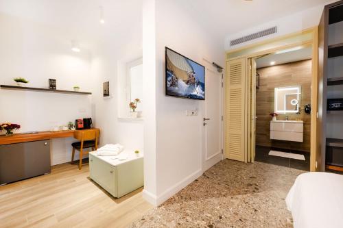 a living room with a bed and a desk in a room at Battistini Boutique Living and Spa, Victoria, Gozo in Victoria