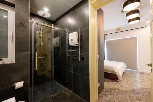 a bathroom with a shower with a glass door at Battistini Boutique Living and Spa, Victoria, Gozo in Victoria