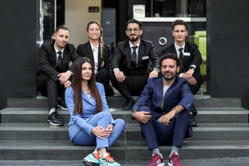 a group of people sitting on the steps of a building at Reggia Suite Spa Hotel in Caserta