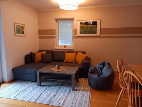 a living room with a couch and a table at Gemütliche Familienwohnung in Lannach