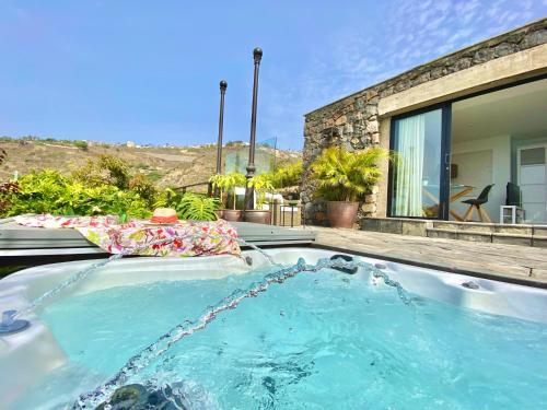 a hot tub in the backyard of a house at Casa Lava Luminosa y con Magníficas Vistas in La Orotava