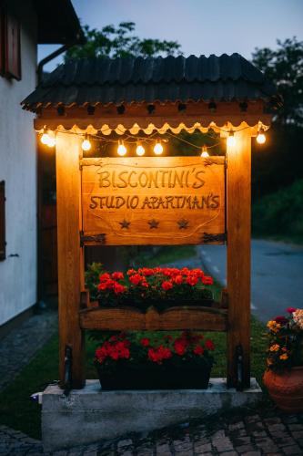 a sign for a flower shop with flowers and lights at Biscontini's Studio in Praid
