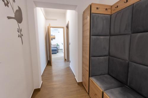 a hallway with a bench in a house at Apartma PUHAN 